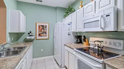 a kitchen with white cabinets and a stove at Windsor Hills Resort 3 Bedroom 4th Floor Condo with Resort Access 0946 in Orlando