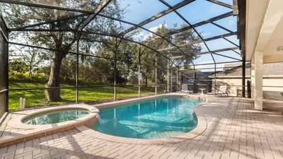 an indoor swimming pool with a glass roof at Windsor Hills Resort 6 Bedroom Home Incredible Game Room 0852 in Orlando