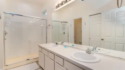 a bathroom with two sinks and a shower at Windsor Hills Resort 5 Bedroom Home with Game Room 0851 in Orlando