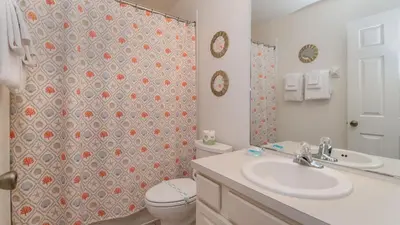 a bathroom with a toilet and a sink and a shower at Windsor Hills Resort 5 Bedroom Home with Game Room 0851 in Orlando
