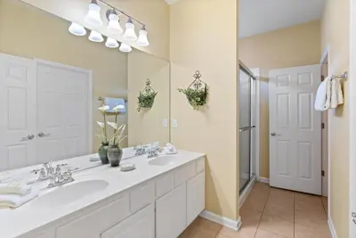 a bathroom with two sinks and a large mirror at Windsor Hills Resort 5 Bedroom Private Pool Home 0869 in Orlando