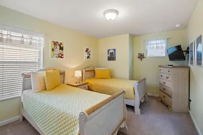 a bedroom with two beds and a dresser at Windsor Hills Resort 5 Bedroom Private Pool Home 0869 in Orlando