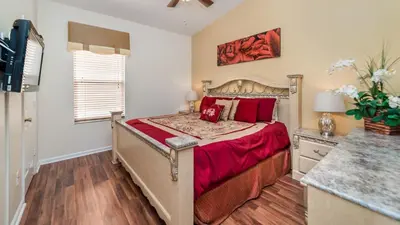 a bedroom with a bed with red pillows at Windsor Palms Resort 4 Bedroom Home With Game Room 0843 in Kissimmee