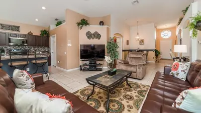 a living room with a couch and a table at Windsor Palms Resort 4 Bedroom Home With Game Room 0843 in Kissimmee