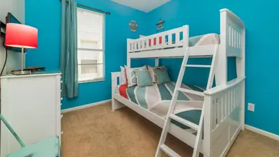 a bedroom with blue walls and a bunk bed at Windsor Palms Resort 4 Bedroom with Game Room 0878 in Kissimmee