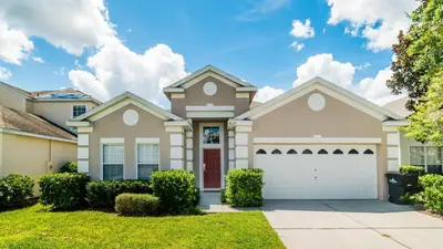 a house with a garage in a residential neighborhood at Windsor Palms Resort 4 Bedroom with Game Room 0878 in Kissimmee