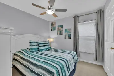 a white bedroom with a bed and a ceiling fan at Windsor Palms Resort 4 Bedroom with Game Room 0882 in Kissimmee