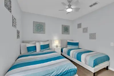 two beds sitting next to each other in a bedroom at Windsor Palms Resort 4 Bedroom with Game Room 0882 in Kissimmee