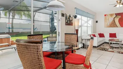 a dining room with a glass table and chairs at Windsor Palms Resort 6 Bedroom with Game Room 0847 in Kissimmee