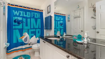 a bathroom with a penguin shower curtain and a sink at Windsor Palms Resort 6 Bedroom with Pool Spa 0877 in Kissimmee