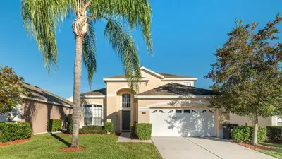 a palm tree in front of a house at Windsor Palms Resort 6 Bedroom with Pool Spa 0877 in Kissimmee