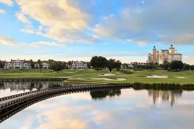 a view of a golf course with a bridge over a lake at AQ0401 Villas North Charm in Orlando