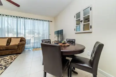 a dining room with a table and chairs and a couch at MSW2505 in Orlando
