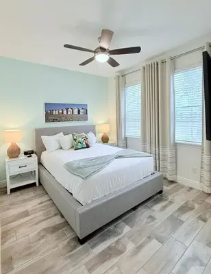 a bedroom with a bed and a ceiling fan at Just Lauched - Luxury & Cozy 3BR near Disney-Margaritaville in Orlando