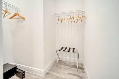 a white room with a chair and a curtain at Just Lauched - Luxury & Cozy 3BR near Disney-Margaritaville in Orlando