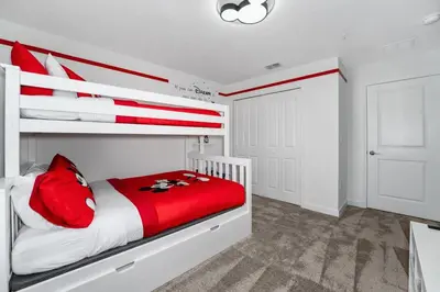 a bedroom with a red and white bunk bed at Family Mickey & Star Wars - FREE Heated Pool in Kissimmee