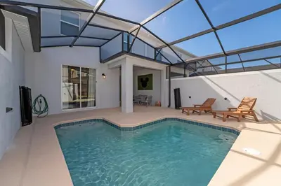 a swimming pool in a house with a roof at Family Mickey & Star Wars - FREE Heated Pool in Kissimmee