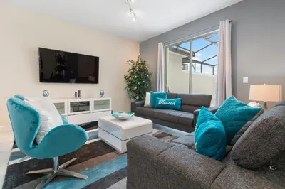 a living room with a couch and a chair at Villa Kerpen - Storey Lake in Kissimmee