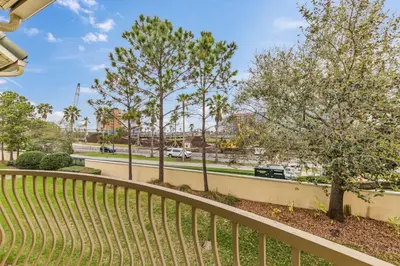 a fence with trees and a road in the background at 5014 Tideview Circle 9 in Orlando