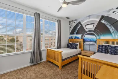 a bedroom with two beds and a window at 5014 Tideview Circle 9 in Orlando