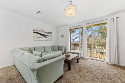 a living room with a couch and a window at 5014 Tideview Circle 9 in Orlando