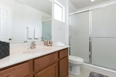 a bathroom with a sink and a toilet and a shower at Villa Martins, Bella Vida in Kissimmee