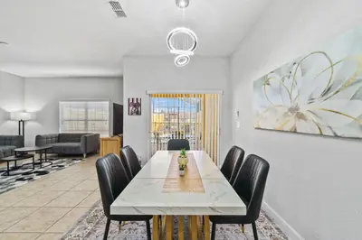 a dining room with a table and chairs at Lakefront 4 Bed private Oasis Location in Kissimmee