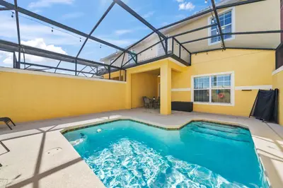 a swimming pool in the backyard of a house at Lakefront 4 Bed private Oasis Location in Kissimmee