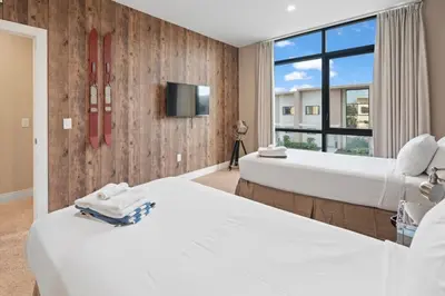 a hotel room with two beds and a tv at 4BD and 4.5BA Amazing Villa with Private Hot Tub (3091) in Orlando