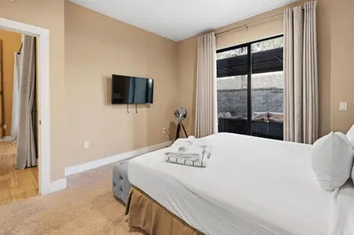 a bedroom with a large white bed with a window at 4BD and 4.5BA Amazing Villa with Private Hot Tub (3091) in Orlando