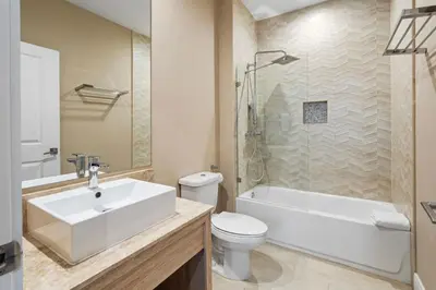 a bathroom with a sink and a toilet and a shower at 4BD and 4.5BA Amazing Villa with Private Hot Tub (3091) in Orlando
