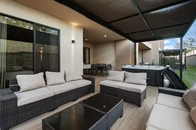 a patio with two couches and a table at 4BD and 4.5BA Amazing Villa with Private Hot Tub (3091) in Orlando