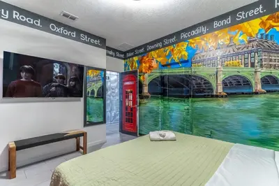 a room with a bed and a red phone booth at Brand New 15BR Mansion Pool Spa Close to Disney in Kissimmee