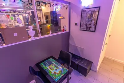 a purple room with a pinball machine in a store at Brand New 15BR Mansion Pool Spa Close to Disney in Kissimmee