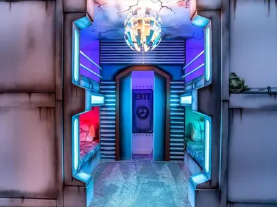 a hallway with a spiral staircase with a chandelier at Brand New High End 9BR Villa in Storey Lake Resort in Kissimmee