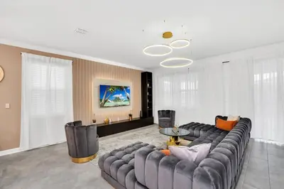 a living room with a couch and a table at Brand New High End 9BR Villa in Storey Lake Resort in Kissimmee