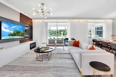 a living room with a white couch and a table at Brand New Luxury 9BR Villa Pool Spa Game Room in Kissimmee