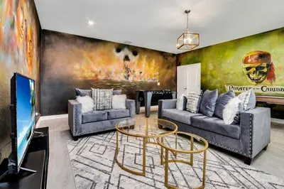 a living room with two couches and a tv at Brand New Storey Lake 8BR Villa with Lake View in Kissimmee