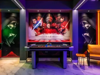 a room with a marvel movie poster on the wall at Brand New Storey Lake 9BR Villa Summer Kitchen in Kissimmee