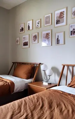 two beds in a bedroom with pictures on the wall at 4184PD Weekly Stay 5BR Free Water Park in Kissimmee