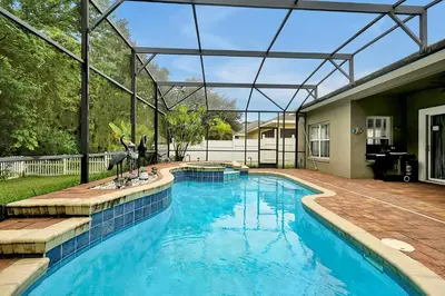 a swimming pool in a house with a glass roof at 11326 CYPRESS TRAIL DRIVE ORLANDO 3BED in Orlando