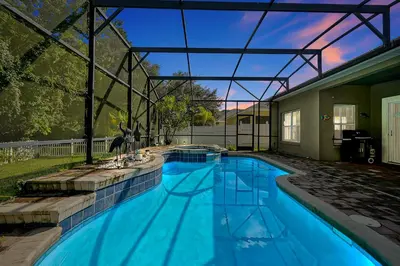 a large swimming pool with a glass roof at 11326 CYPRESS TRAIL DRIVE ORLANDO 3BED in Orlando