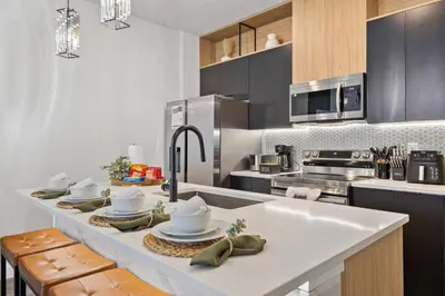 a kitchen with a counter with dishes on it at 3251 The Hub escape with flex space in Kissimmee