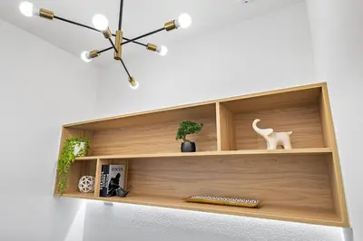 a wooden shelf on a wall with a cat on it at 3251 The Hub escape with flex space in Kissimmee