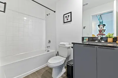 a bathroom with a toilet and a tub and a sink at 3251 The Hub escape with flex space in Kissimmee
