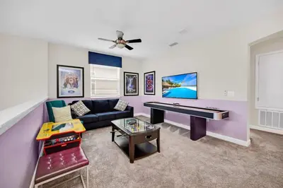 a living room with a couch and a piano at Dazzling 5BR Villa in Storey Lake with Pool & Spa 1528 in Kissimmee