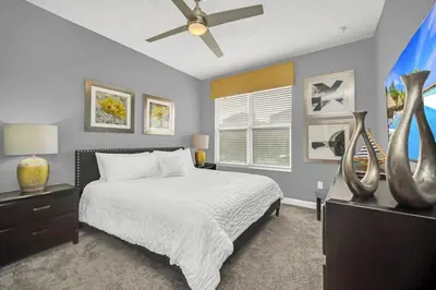 a bedroom with a bed and a ceiling fan at Dazzling 5BR Villa in Storey Lake with Pool & Spa 1528 in Kissimmee