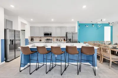 a kitchen with a large blue island in a room at DeepSea World 15 Suites Sleep 30 Oversize Pool Spa in Kissimmee