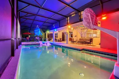 a swimming pool with a basketball hoop in a house at DeepSea World 15 Suites Sleep 30 Oversize Pool Spa in Kissimmee