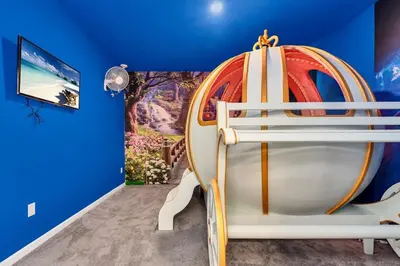 a childs room with a spaceship bed in a blue wall at DeepSea World 15 Suites Sleep 30 Oversize Pool Spa in Kissimmee